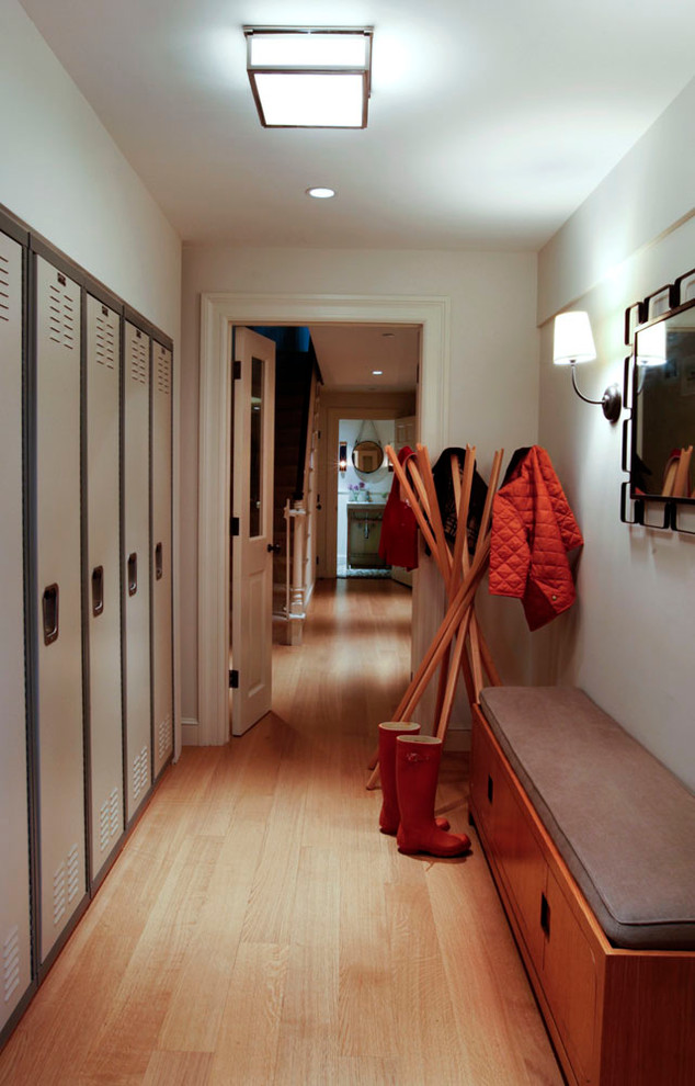 Design ideas for a medium sized modern hallway in New York with white walls and medium hardwood flooring.