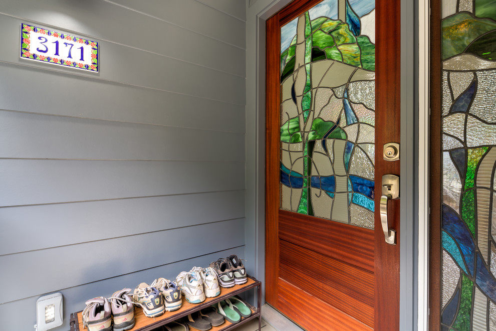 Inspiration for a mid-sized transitional painted wood floor entryway remodel in Hawaii with blue walls and a dark wood front door