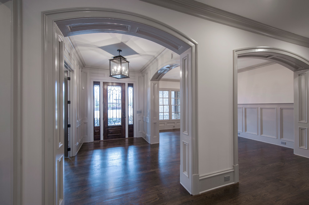 Mid-sized elegant dark wood floor entryway photo in Atlanta with white walls and a dark wood front door