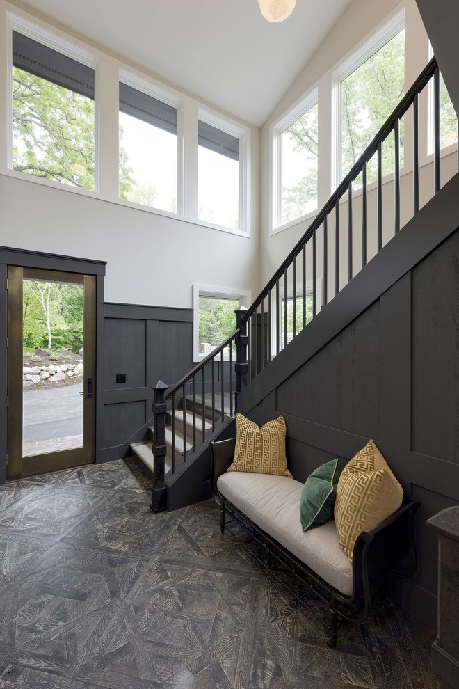 This is an example of a medium sized traditional foyer in Minneapolis with grey walls, a single front door, a glass front door and brown floors.