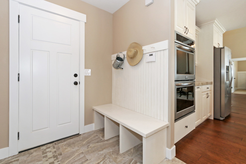 Photo of a medium sized traditional boot room in Salt Lake City with beige walls, ceramic flooring, a single front door and a white front door.