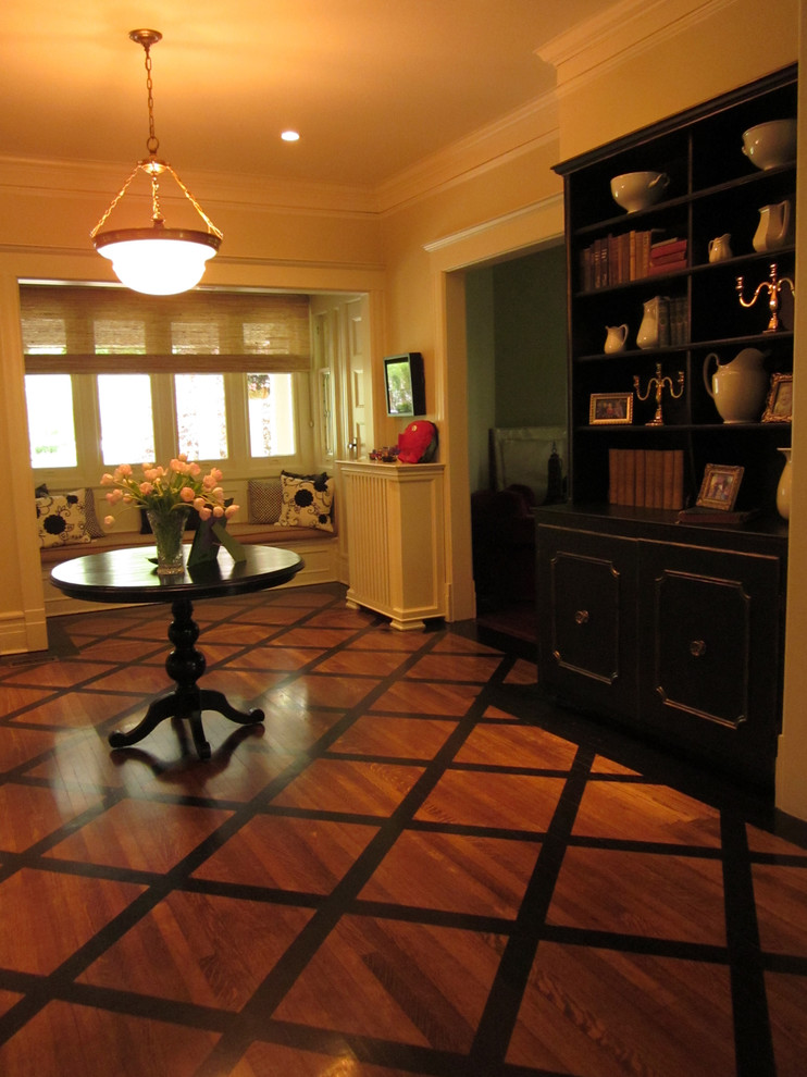 Foyer - large traditional painted wood floor foyer idea in New York with beige walls