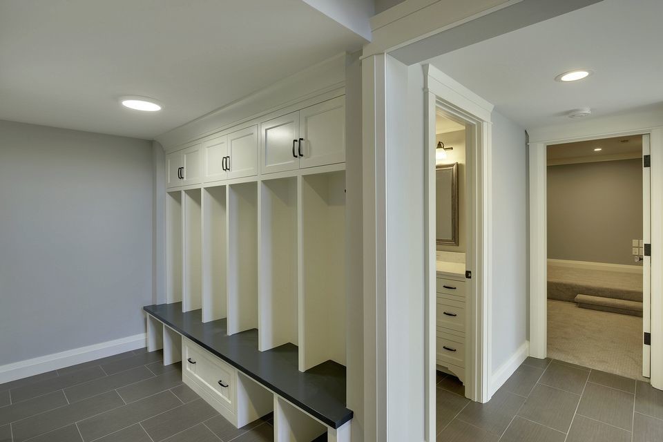 Example of a mid-sized transitional porcelain tile mudroom design in Minneapolis with gray walls