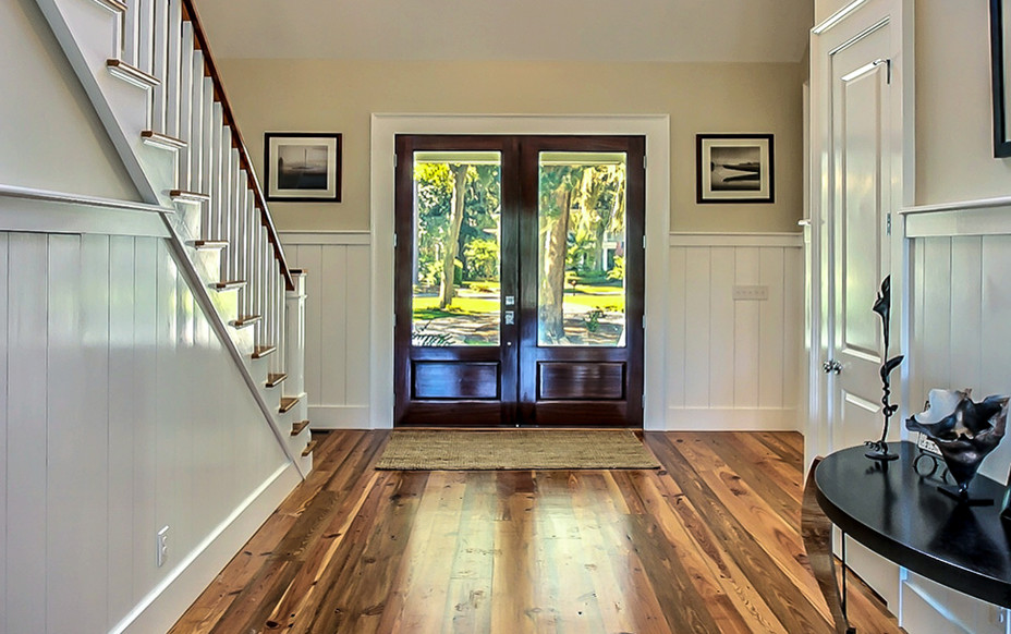 Entryway - mid-sized modern medium tone wood floor entryway idea in Other with multicolored walls and a dark wood front door
