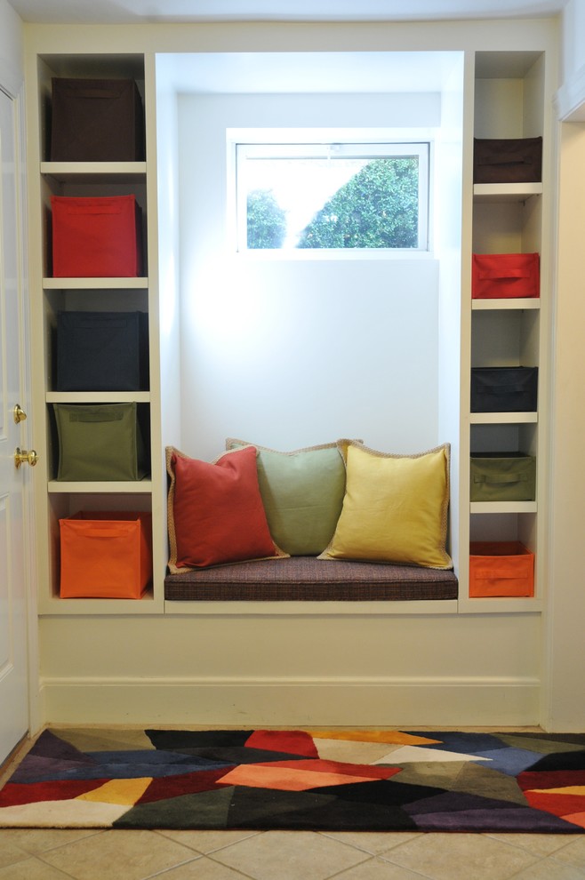 This is an example of a medium sized contemporary boot room in Boston with white walls, ceramic flooring, a single front door, a white front door and grey floors.