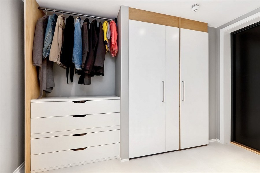 This is an example of a small modern wardrobe in Other with porcelain flooring.