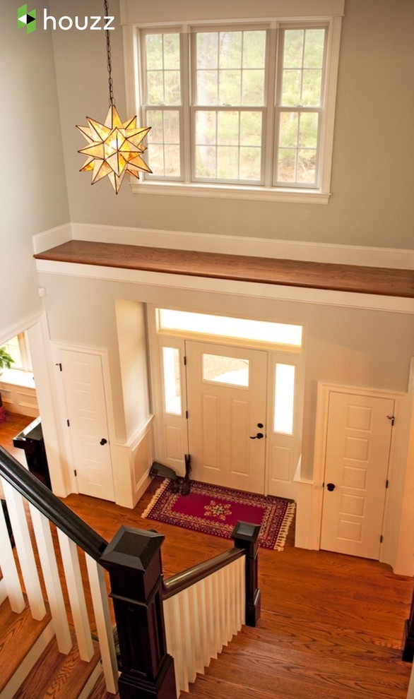 Design ideas for a medium sized classic foyer in Boston with grey walls, medium hardwood flooring, a single front door, a red front door and brown floors.