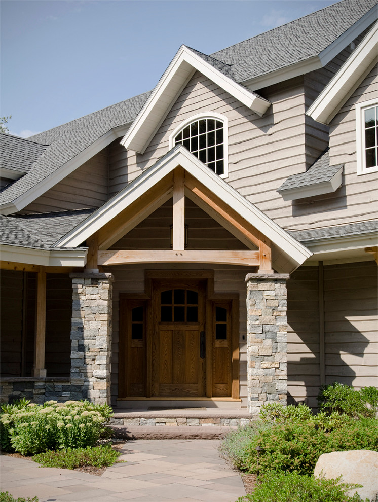 Example of a large classic entryway design in Boston with a medium wood front door