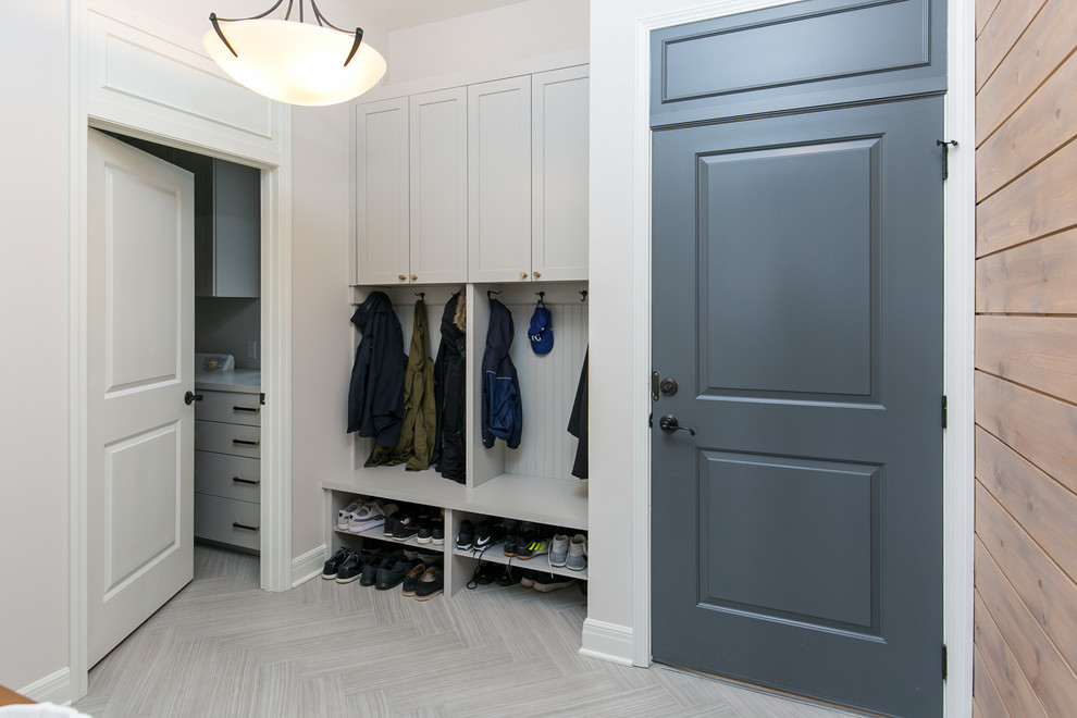 Photo of a medium sized contemporary boot room in Kansas City with white walls, porcelain flooring, a blue front door and white floors.