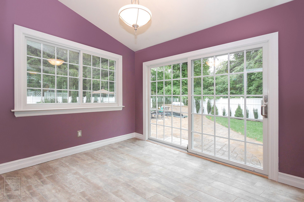 This is an example of a medium sized boot room in New York with pink walls, ceramic flooring, a double front door, a white front door, beige floors and a vaulted ceiling.
