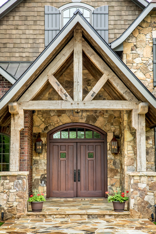 Photo of a rustic porch in Charlotte with a double front door and a dark wood front door.
