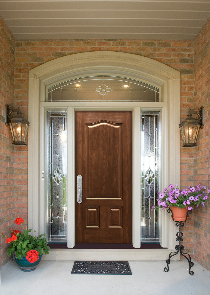 Inspiration for a large timeless gray floor entryway remodel in Other with brown walls and a dark wood front door