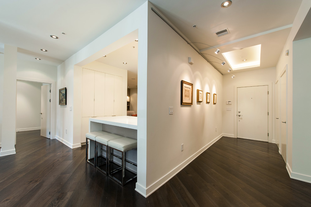 Mid-sized trendy dark wood floor entryway photo in DC Metro with white walls and a white front door