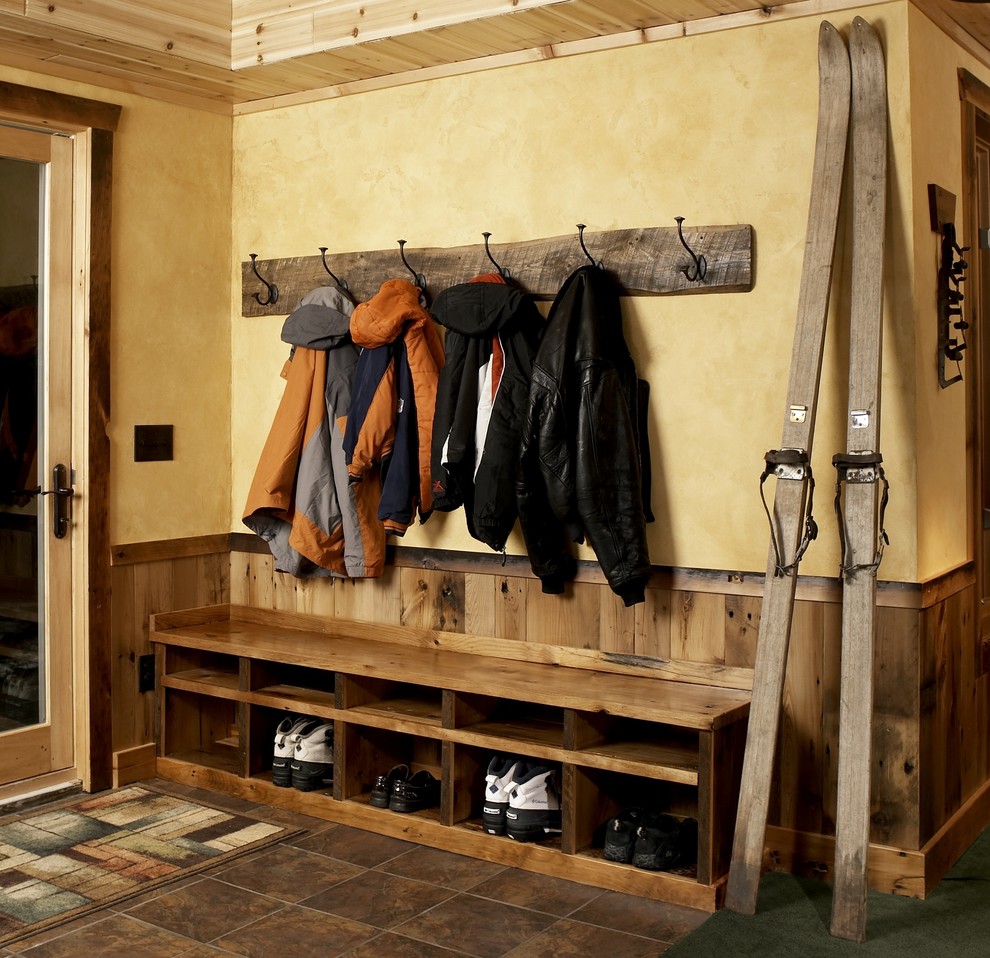 Mountain style porcelain tile entryway photo in Minneapolis with yellow walls