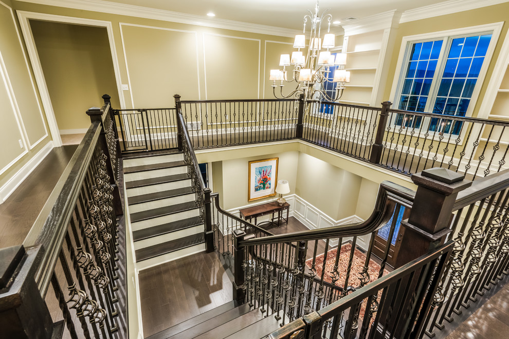 Design ideas for a large traditional foyer in Other with beige walls, dark hardwood flooring and brown floors.