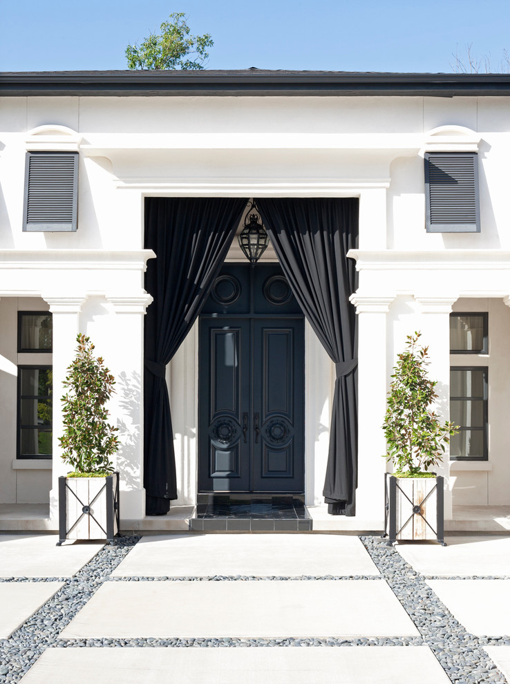 Photo of a mediterranean entrance in Little Rock with white walls.