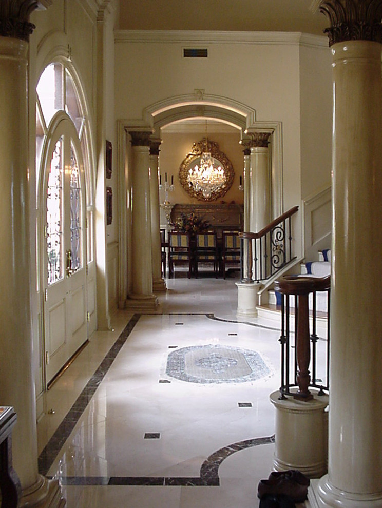 Design ideas for a large victorian foyer in Dallas with white walls, marble flooring and white floors.
