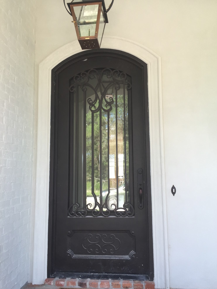 Inspiration for a large mediterranean front door in New Orleans with a single front door and a metal front door.