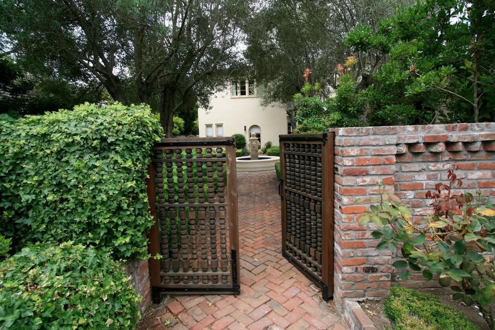 Example of a tuscan entryway design in Other with a dark wood front door