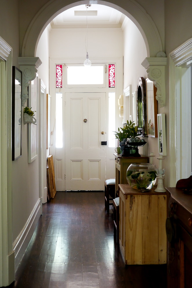 Идея дизайна: узкая прихожая в викторианском стиле с темным паркетным полом, одностворчатой входной дверью и белой входной дверью