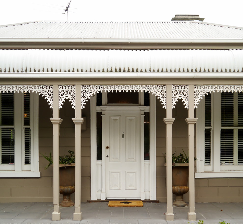 Design ideas for a traditional front door in Melbourne with a white front door.