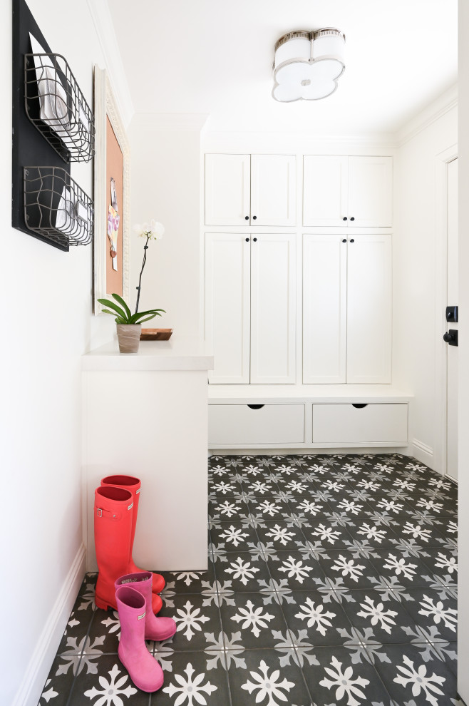 This is an example of a large transitional mudroom in Houston with white walls, a single front door, a white front door and multi-coloured floor.
