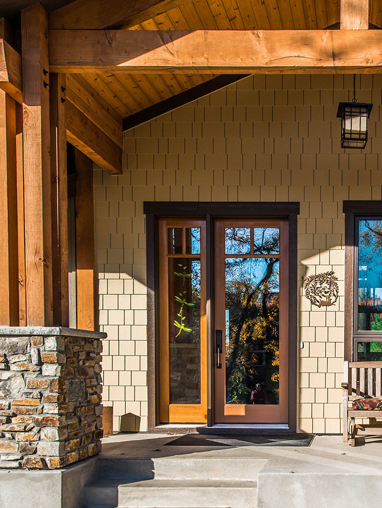 Inspiration for a medium sized traditional front door in Minneapolis with beige walls, concrete flooring, a single front door and a light wood front door.