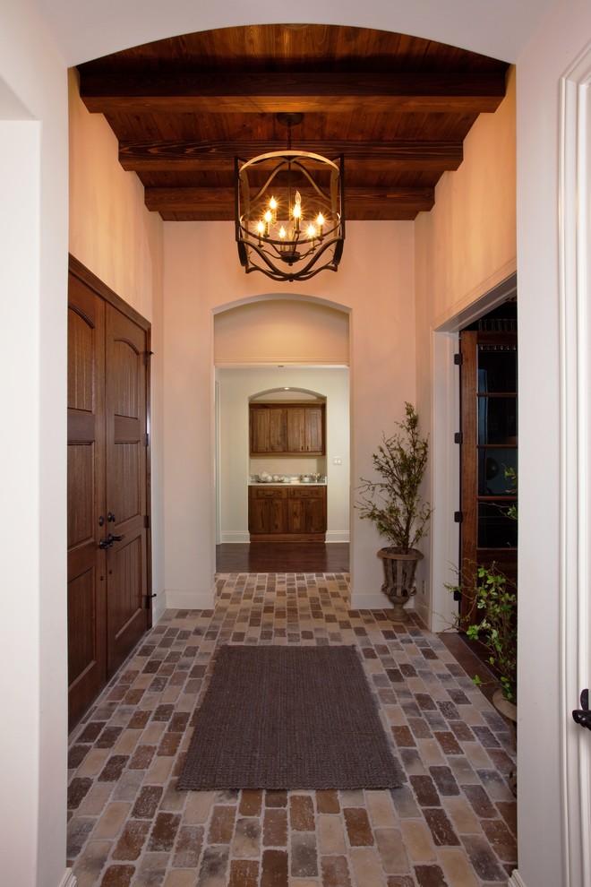 Inspiration for a classic foyer in Austin with white walls, brick flooring, a double front door and a dark wood front door.