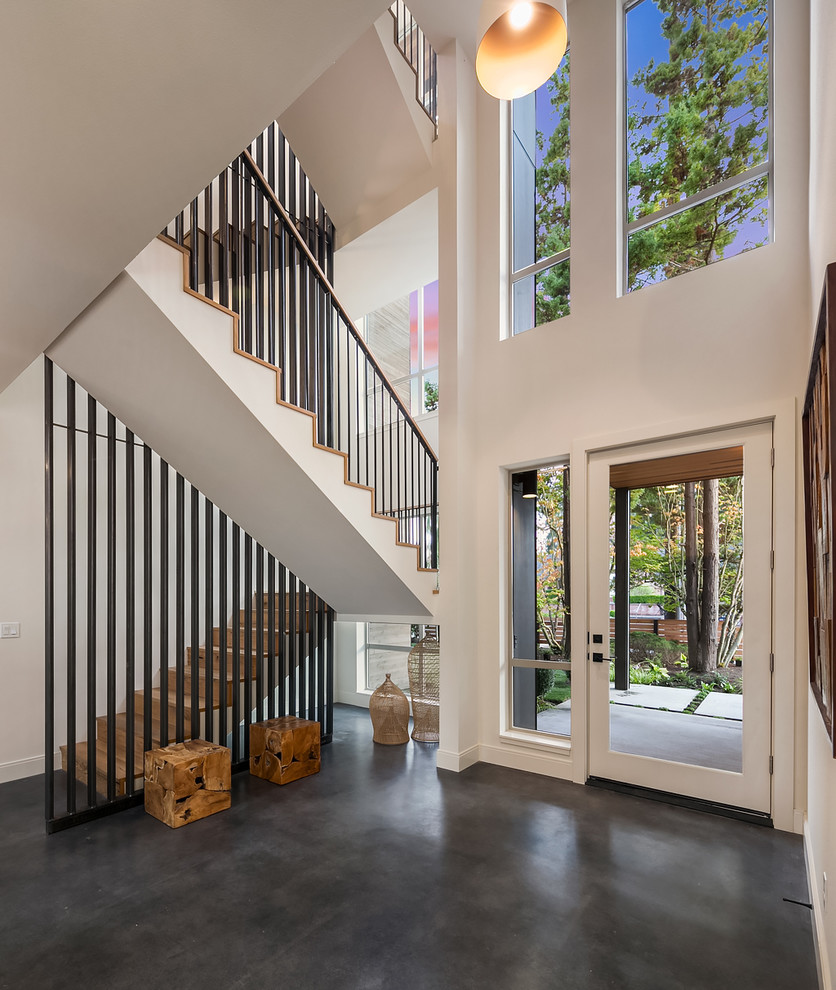 Inspiration for a contemporary entrance in Seattle with white walls, concrete flooring, a single front door, a glass front door and grey floors.