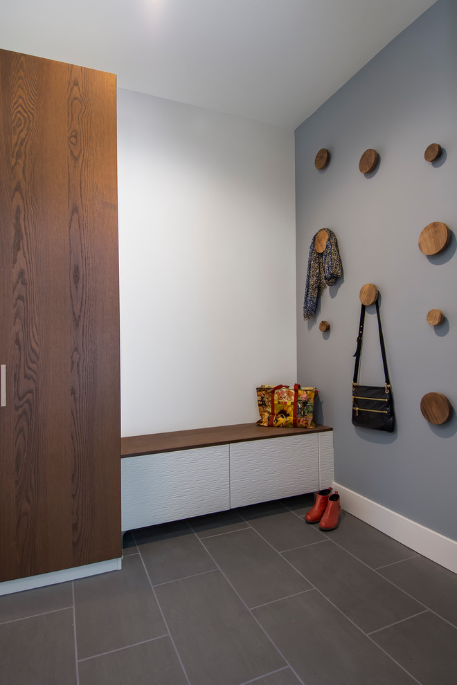 Mudroom - mid-sized modern porcelain tile and gray floor mudroom idea in Seattle with gray walls
