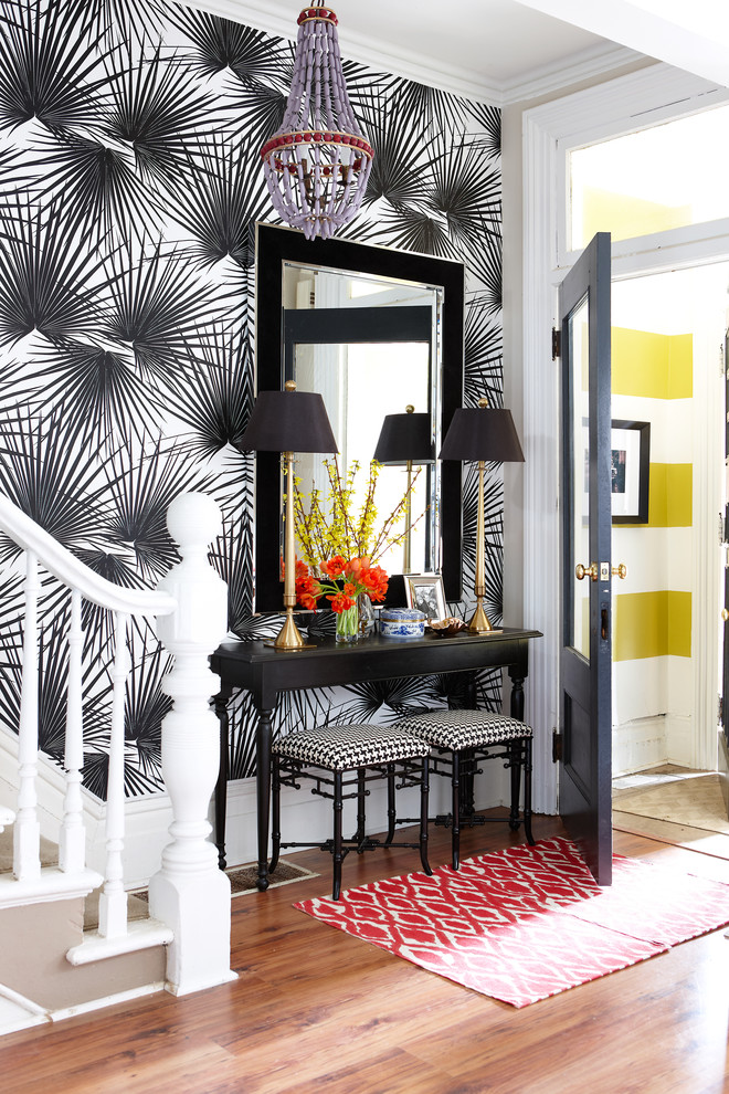 Example of a small trendy medium tone wood floor entryway design in Toronto with multicolored walls