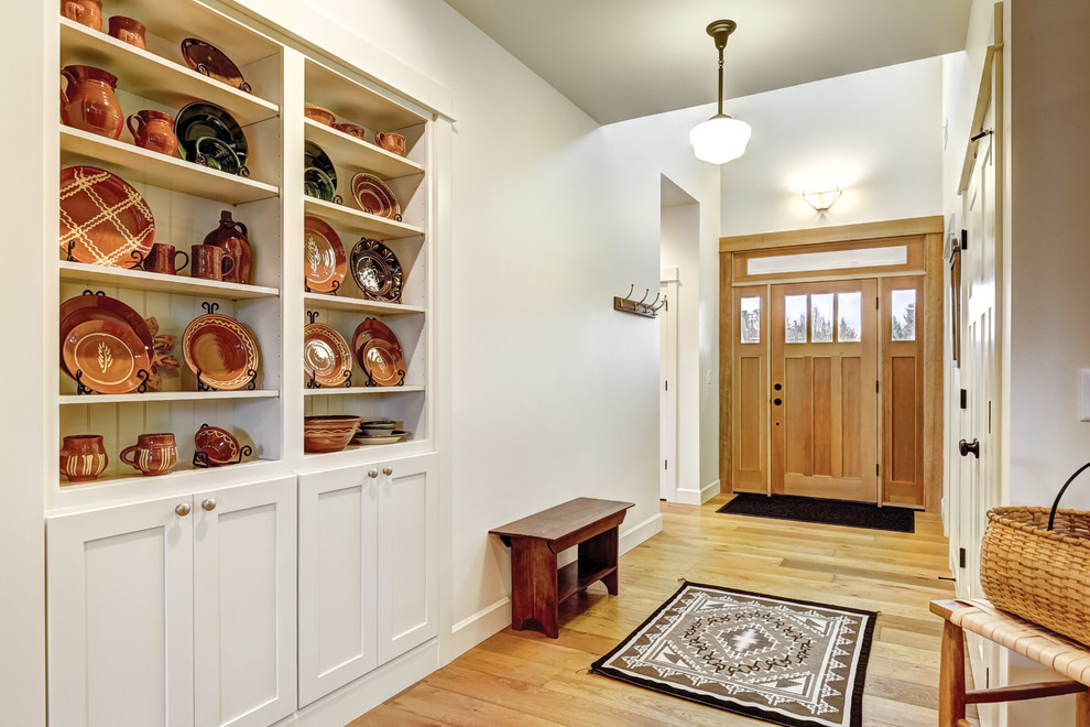 Photo of a medium sized traditional foyer in Portland with white walls, light hardwood flooring, a single front door, a light wood front door and beige floors.