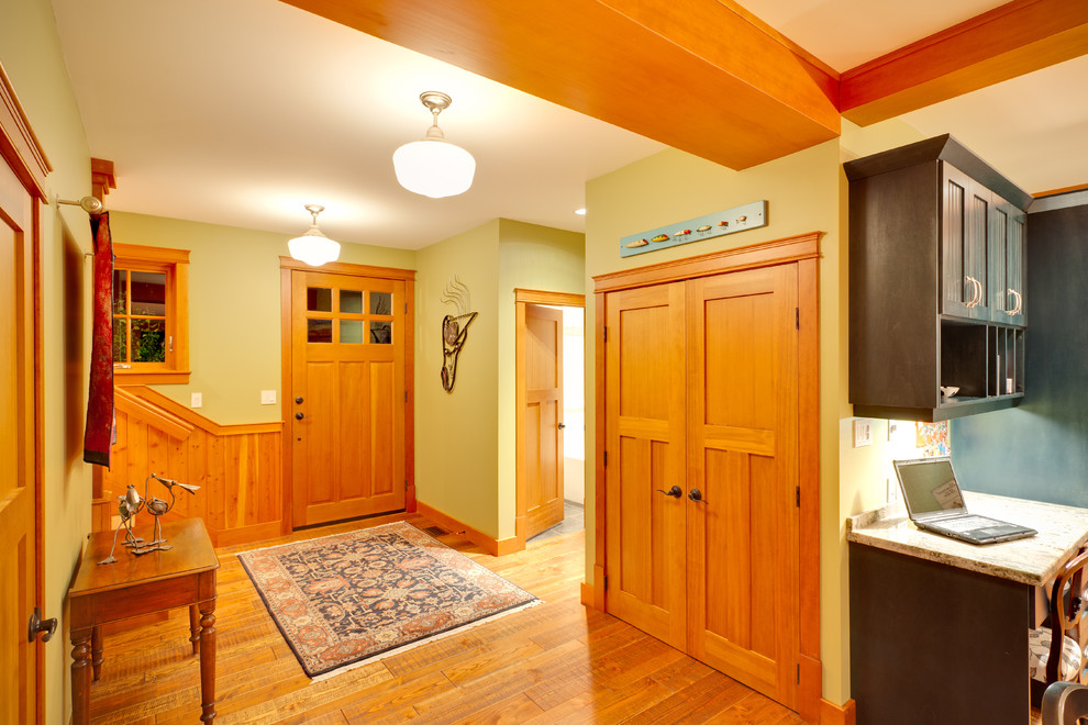 Elegant light wood floor and orange floor entryway photo in Vancouver with green walls and an orange front door