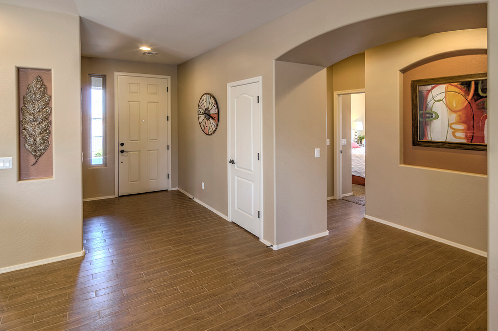 Small southwest ceramic tile entryway photo in Phoenix with beige walls and a white front door