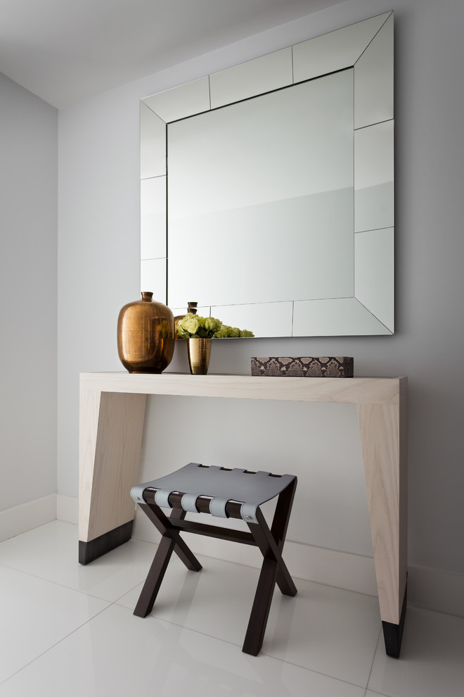 Example of a small trendy ceramic tile entry hall design in Miami with white walls