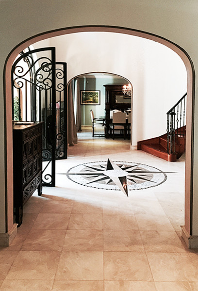 マイアミにある高級な広い地中海スタイルのおしゃれな玄関ホール (ベージュの壁、金属製ドア、ベージュの床) の写真