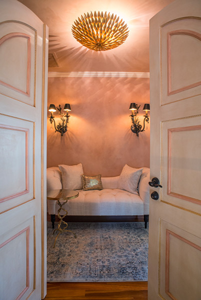 Idées déco pour un grand vestibule méditerranéen avec un mur rose, un sol en bois brun, une porte double et une porte blanche.
