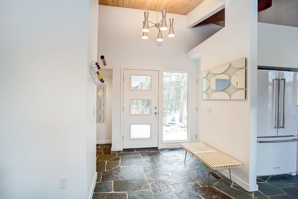 Medium sized retro foyer in Grand Rapids with white walls, slate flooring, a single front door, a white front door and grey floors.