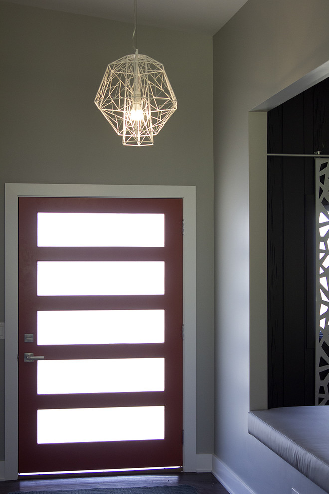 Design ideas for a medium sized midcentury front door in Omaha with beige walls, dark hardwood flooring, a single front door, a glass front door and brown floors.