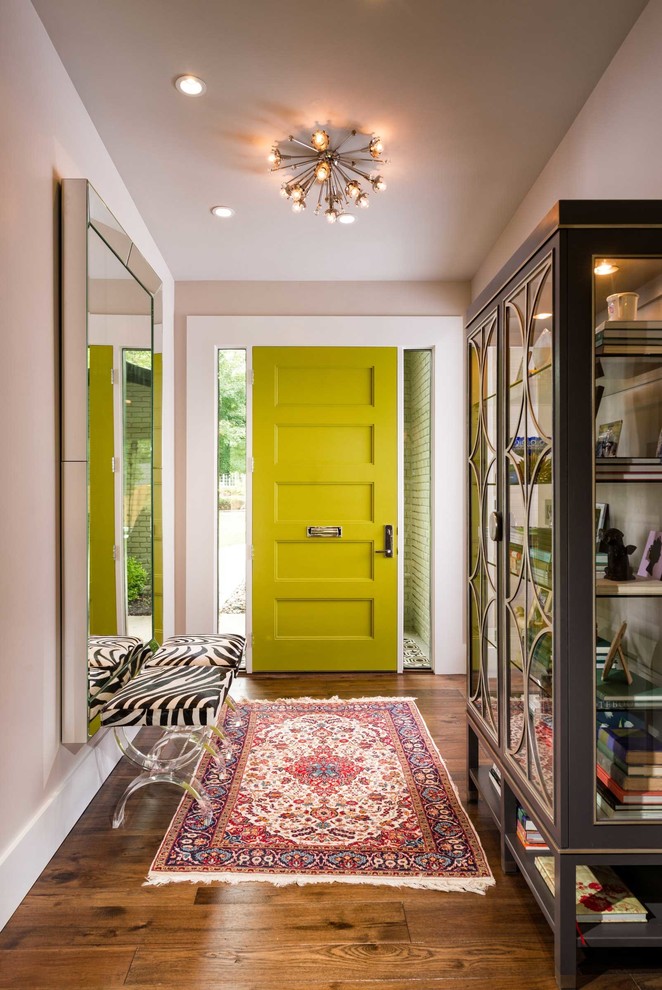 Example of a mid-sized transitional medium tone wood floor entryway design in Other with a green front door