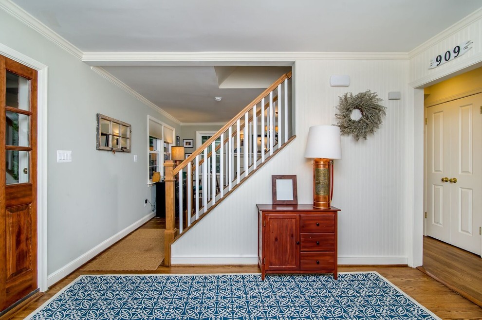 Inspiration for a mid-sized 1960s medium tone wood floor entryway remodel in Baltimore with gray walls and a dark wood front door