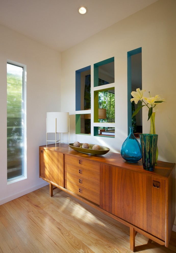 Entryway - 1960s light wood floor entryway idea in Los Angeles with beige walls