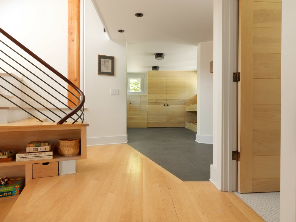 Mid-sized mountain style slate floor entryway photo in Burlington with white walls and a medium wood front door