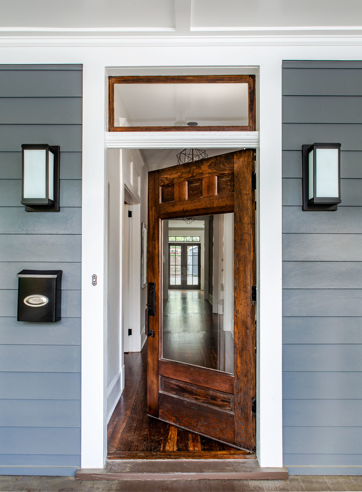 This is an example of a classic entrance in Atlanta with a medium wood front door.