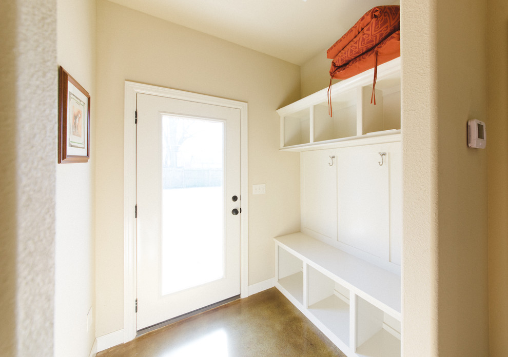 Mid-sized transitional concrete floor and brown floor entryway photo in Other with beige walls