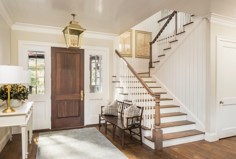 Example of a cottage dark wood floor single front door design in Salt Lake City with beige walls and a dark wood front door