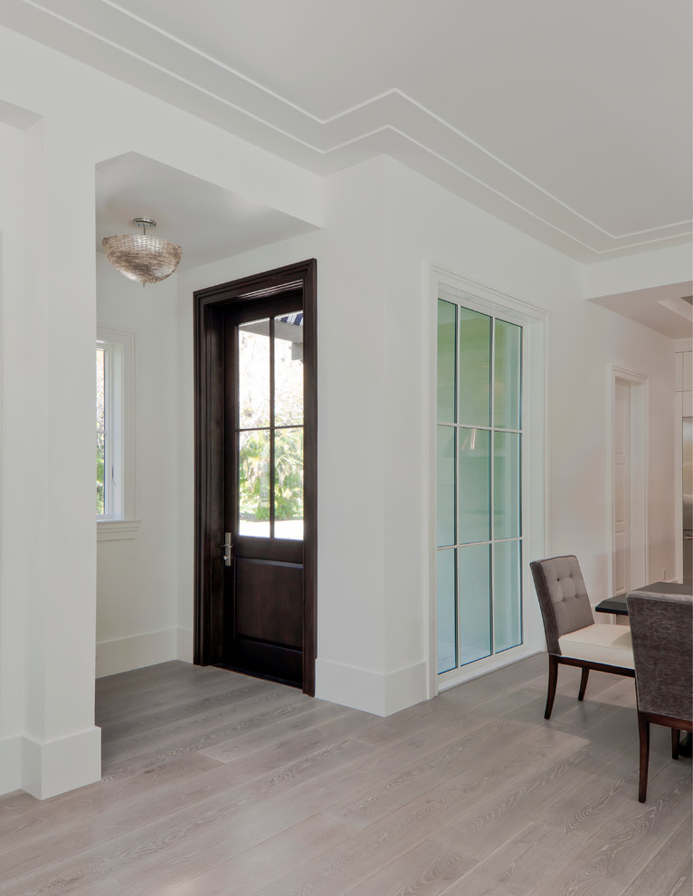 Inspiration for a small transitional light wood floor entryway remodel in Miami with white walls and a dark wood front door