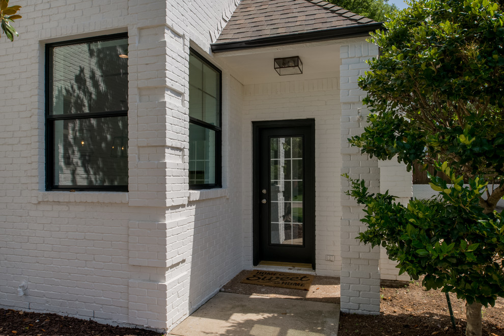 Photo of a medium sized classic front door in Dallas with concrete flooring, a single front door and a black front door.