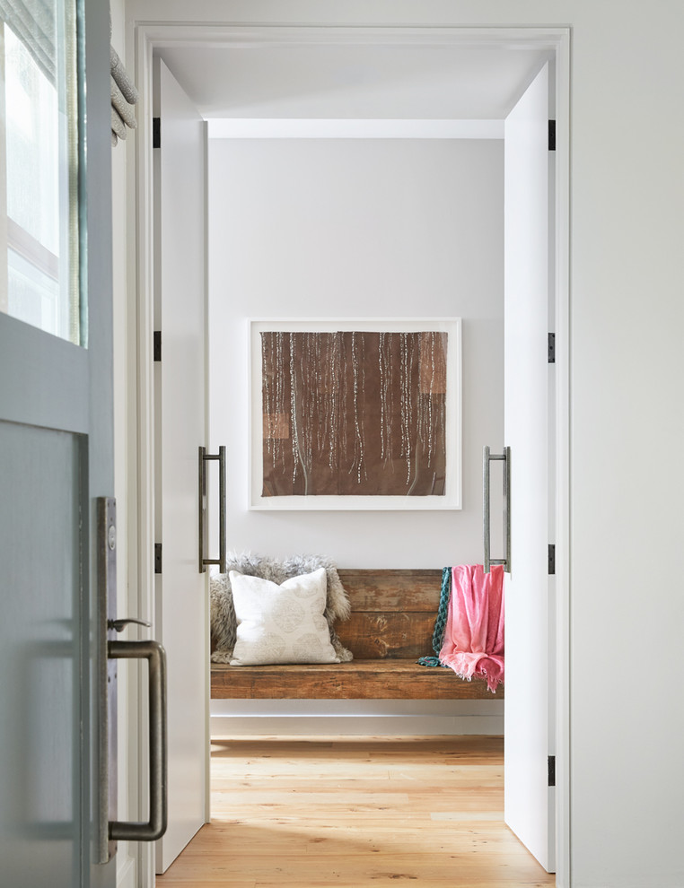 Ispirazione per un ingresso o corridoio scandinavo con pareti bianche, parquet chiaro, una porta a due ante e una porta bianca