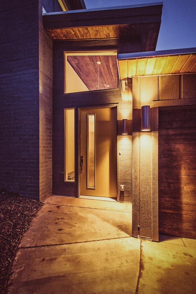 Retro two floor detached house in Salt Lake City with wood cladding and a butterfly roof.